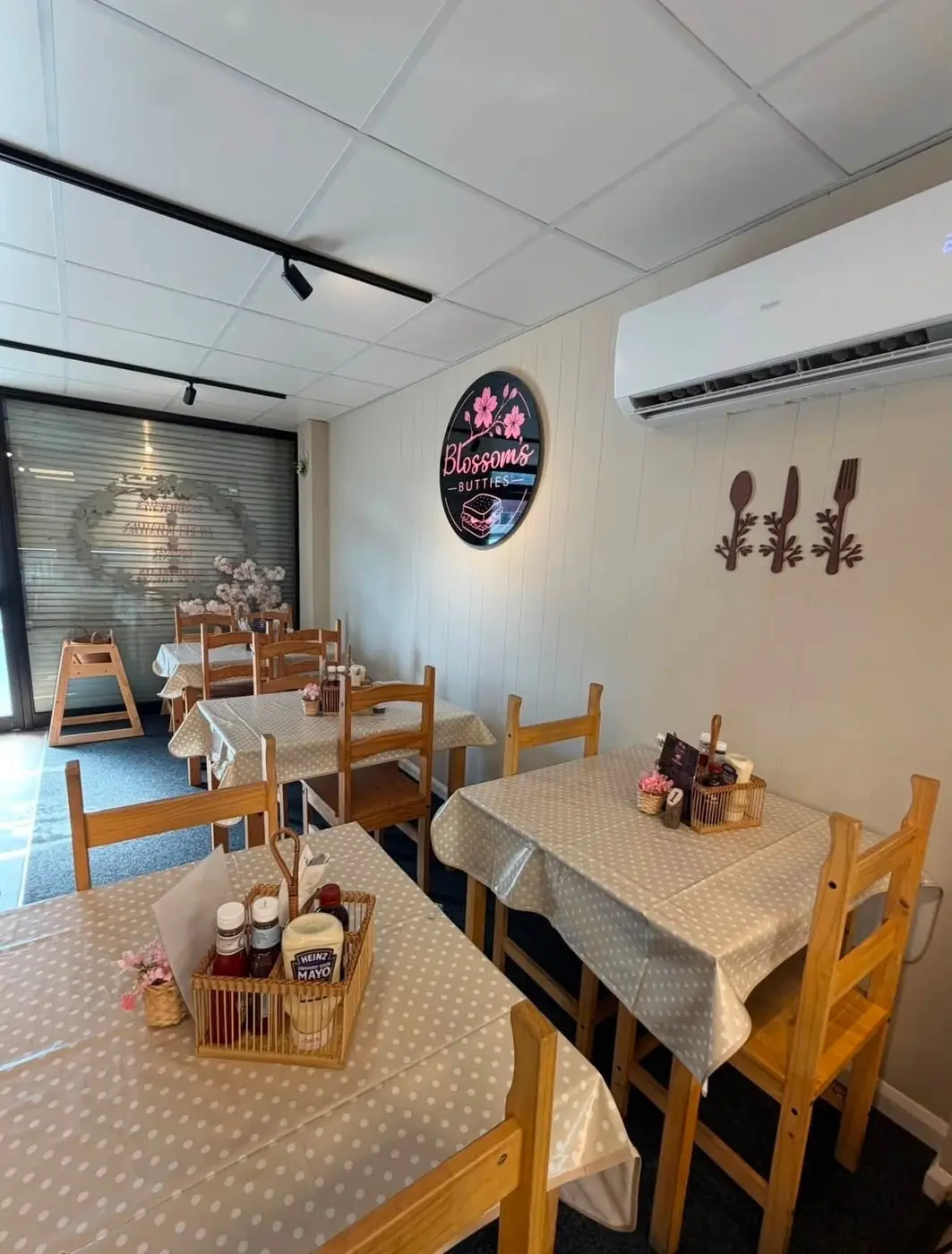 Blossoms Butties cafe seating and illuminated wall logo