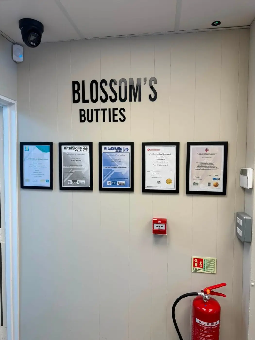 Food hygiene and training certificates displayed inside Blossoms Butties